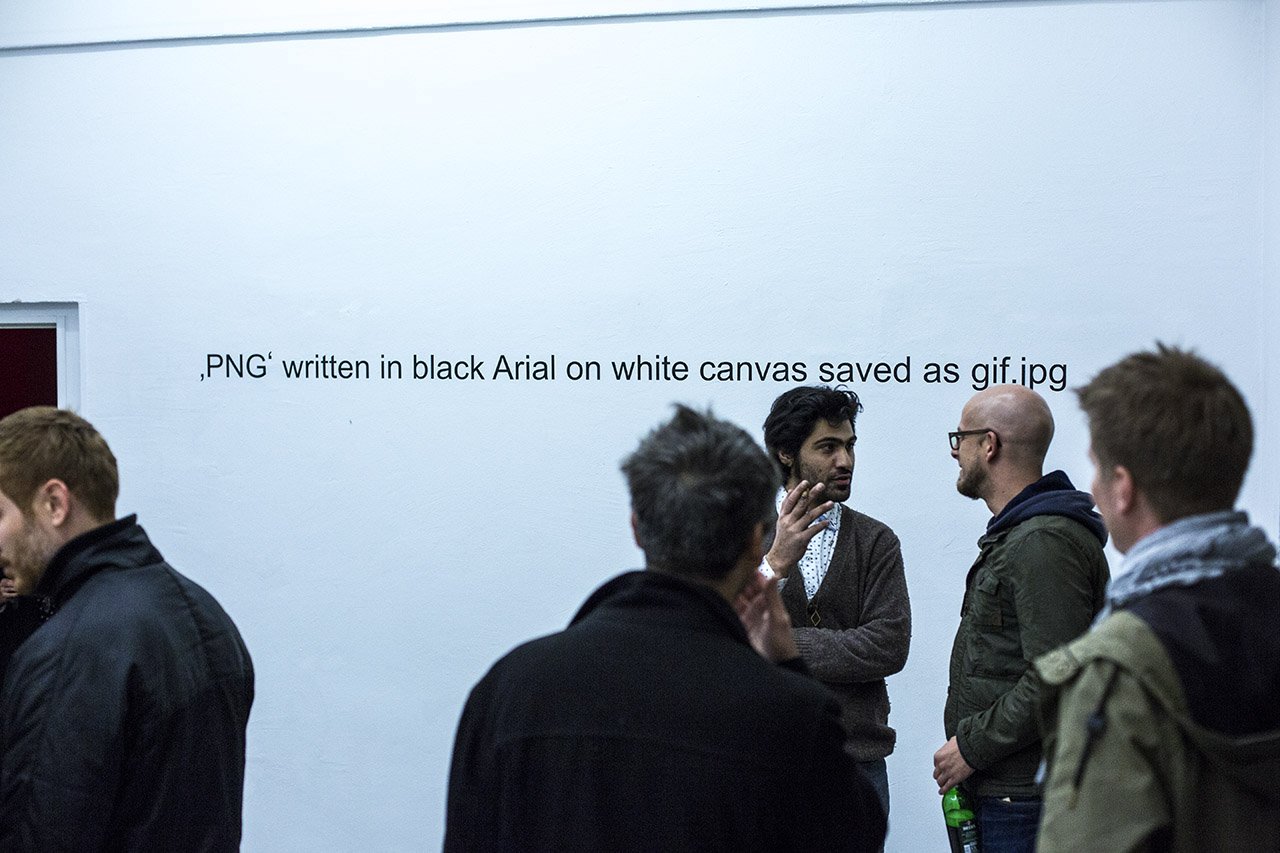 Visitors in front of the wall text PNG written in black Arial on white canvas saved as gif.jpg