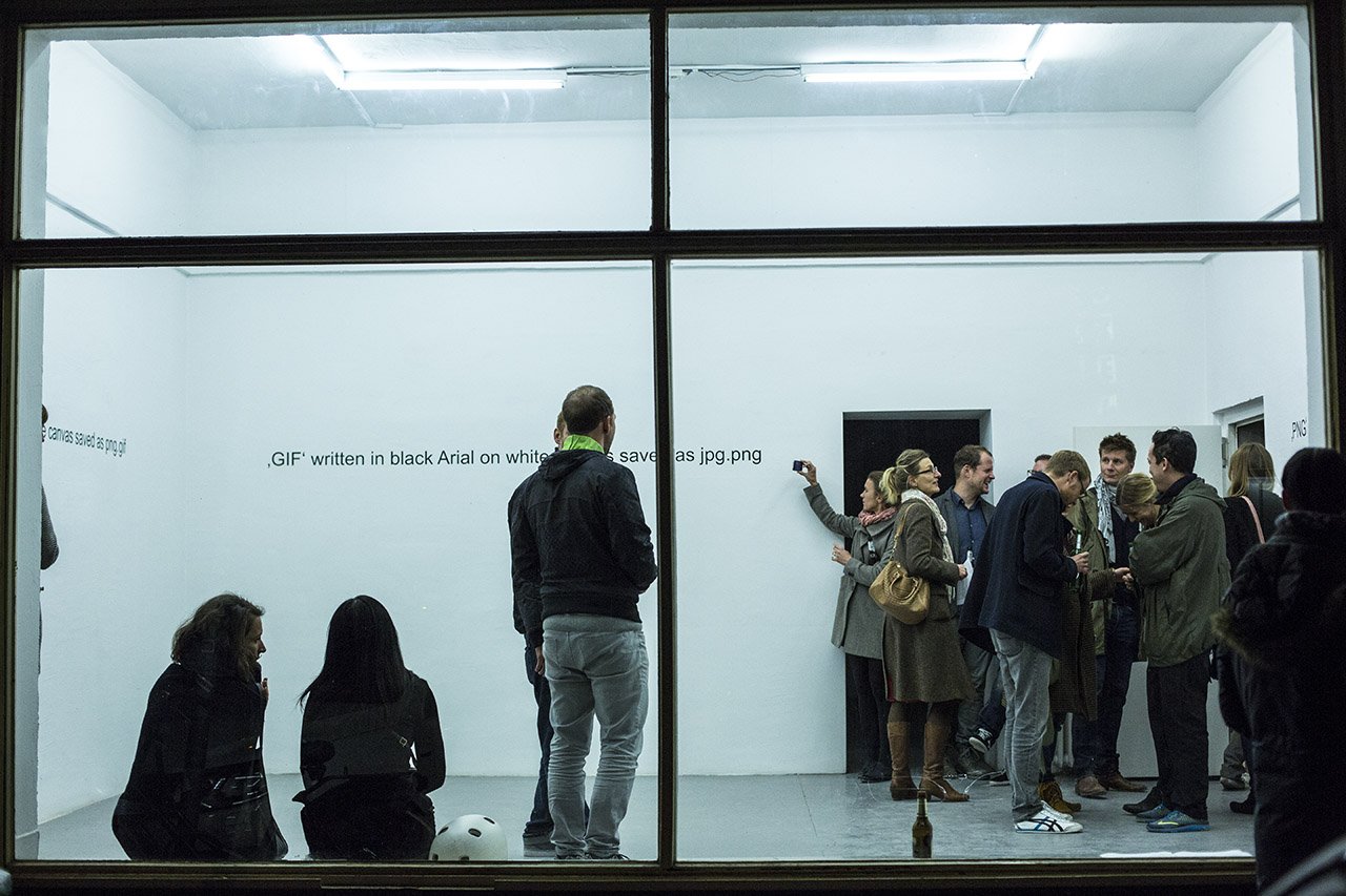 View through the window front into the exhibition room during the opening
