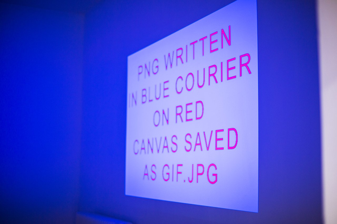 Blue video projection PNG WRITTEN IN BLUE COURIER ON RED CANVAS SAVED AS GIF.JPG