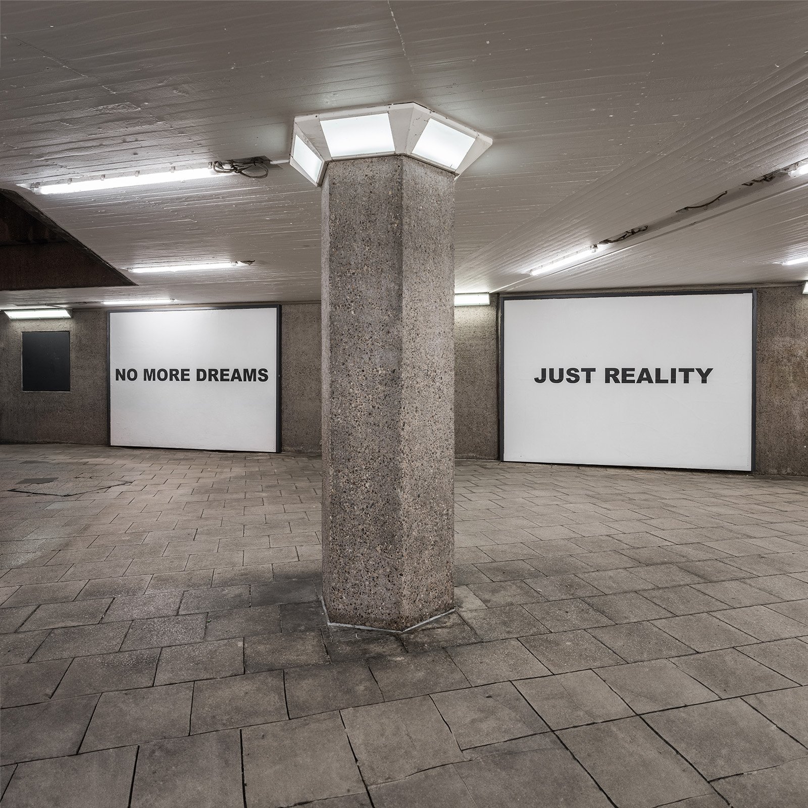 Underpass with the text works NO MORE DREAMS and JUST REALITY